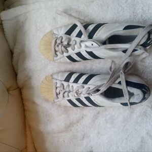 A pair of Adidas Superstar shoes